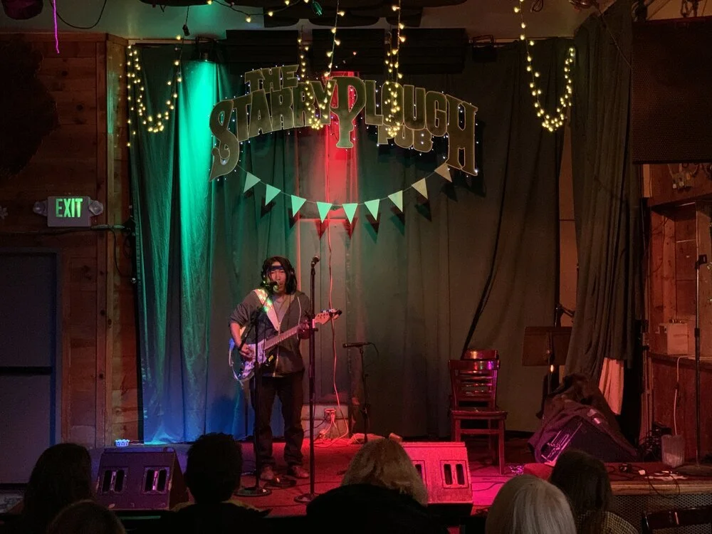 Performer on stage at Starry Plough